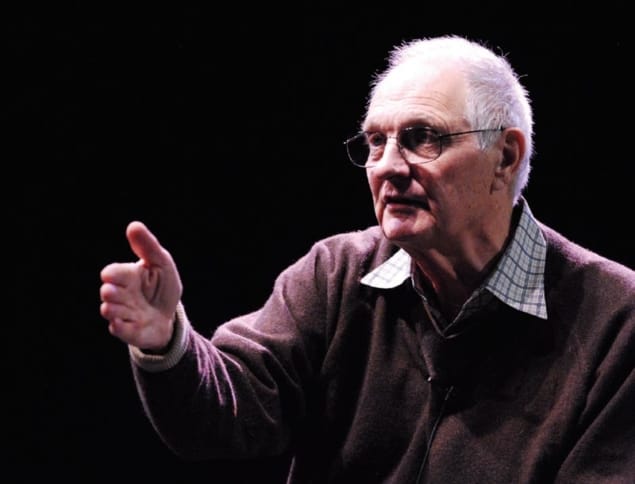 actor Alan Alda gesturing in a dark room actor Alan Alda gesturing in a dark room