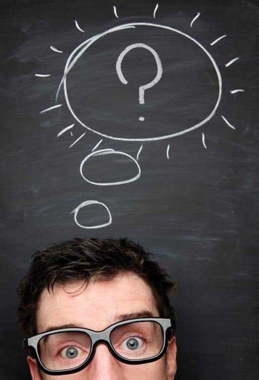 Photo of man in front of a blackboard with a thought bubble drawn on it