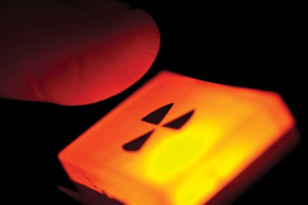 An illustration showing a finger poised over a button with a nuclear symbol on it