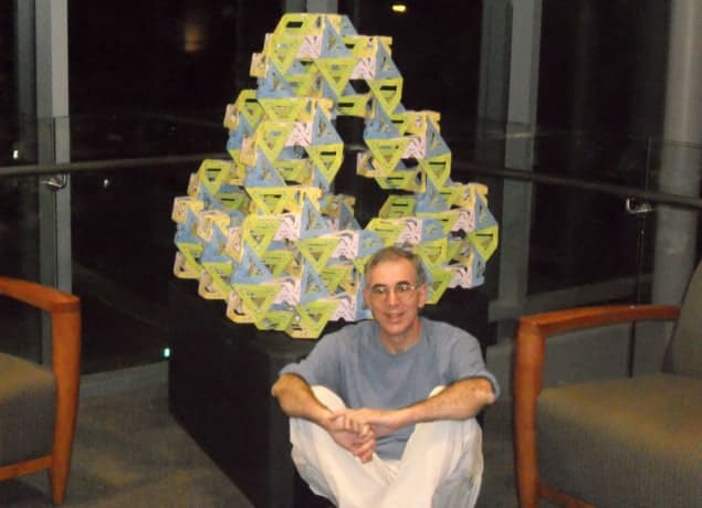Photo of George Hart with his Gyrangle sculpture