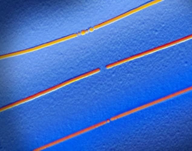Electron micrograph showing three carbon nanotubes memory cells