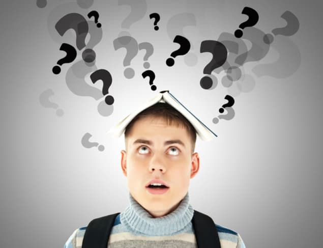Conceptual image of a curious student with a book on his head