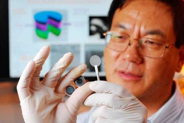 Photograph of Zhong Lin Wang holding the components of a new self-charging power cell