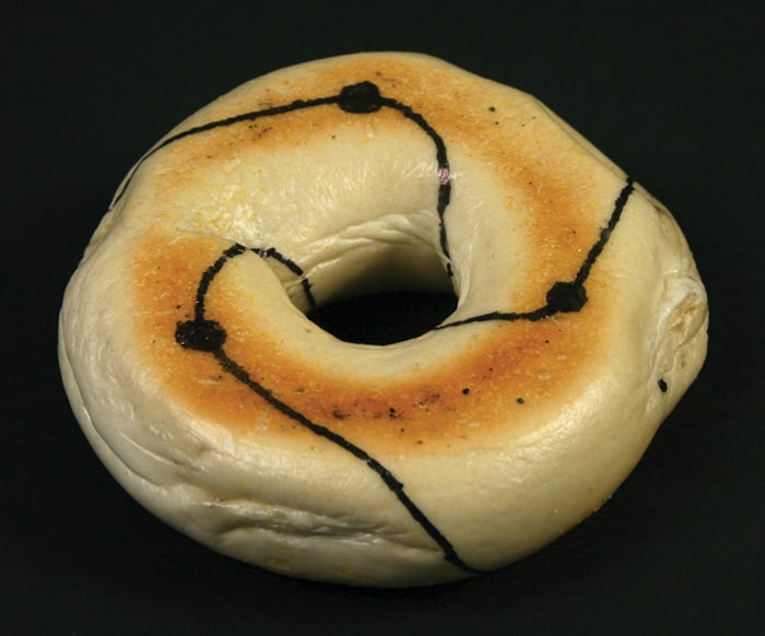 A trefoil knot drawn onto a bagel