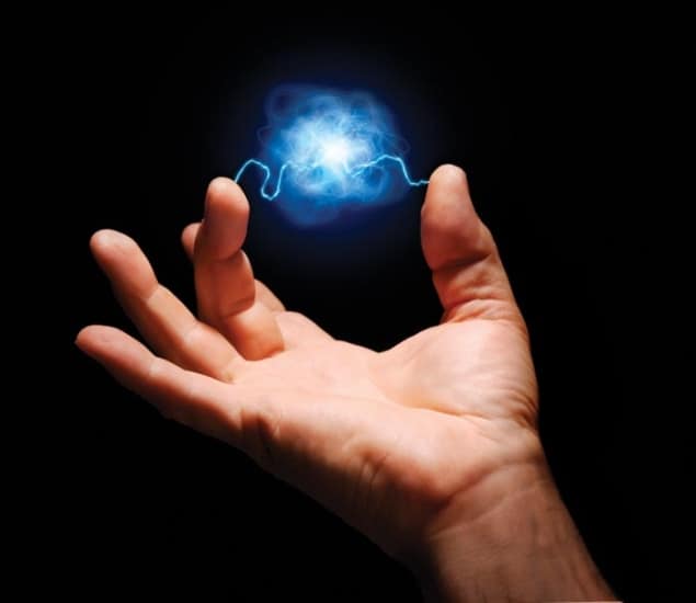 Photo illustration of an electrical spark passing between a person's finger and thumb