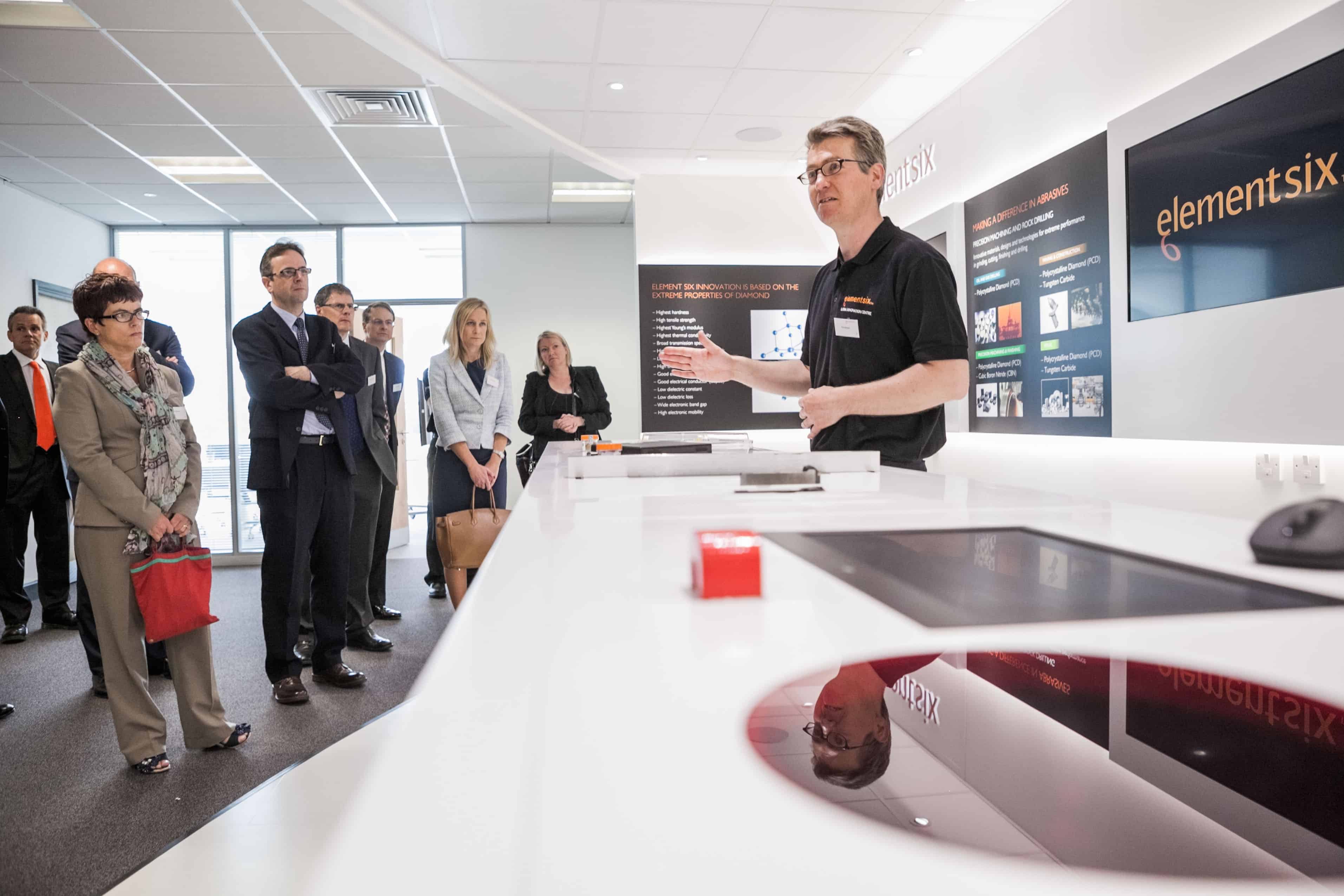 An Element Six employee shows visitors some of the company's products