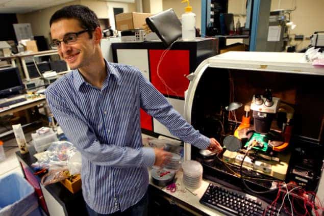 Max Shulaker holding a wafer of carbon-nanotube computers