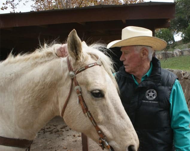 Colour photo of Eugene Cernan and his horse, taken on Cernan’s ranch
