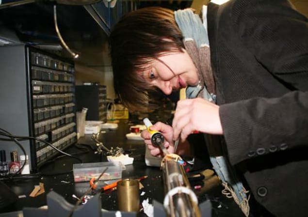 Photograph of physicist Vesna Mitrovic working on equipment in her lab at Brown University