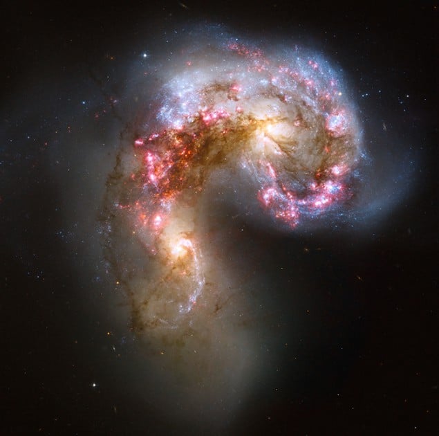 Telescope image of a pair of spiral galaxies in the process of merging into an elliptical galaxy