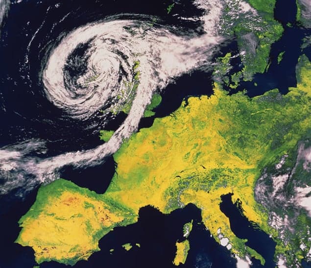 Satellite photo of Western Europe with a swirl of white cloud over the UK and Ireland