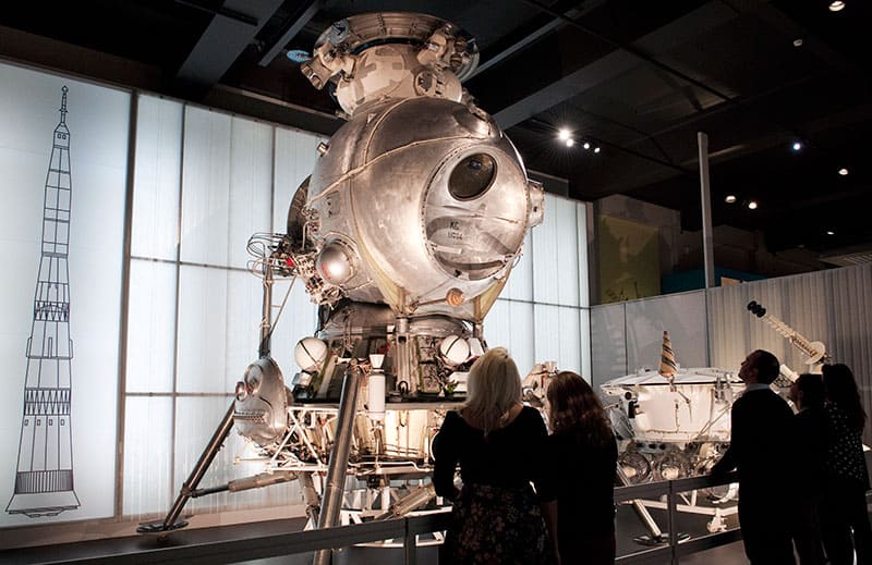 Photo of visitors with an engineering model of the LK-3 lunar lander