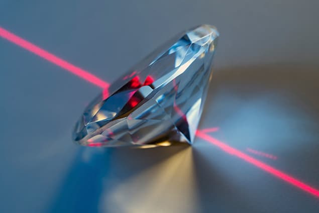 Photograph of a cut diamond and a laser beam