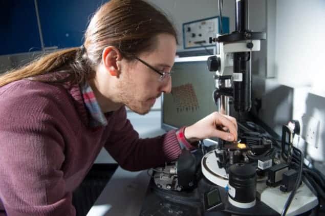 Photograph of Ignacio Martin-Fabiani preparing a paint sample for analysis with an atomic force microscope