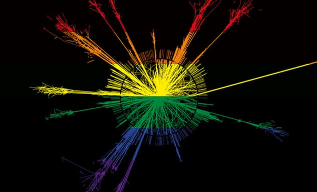 Image of particle tracks emanating radially outwards from a collision point, coloured with the six-coloured Pride flag so that the particle tracks are rainbow-coloured on a black background