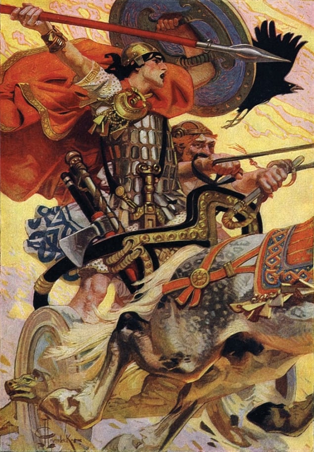 Colour image of a man wearing armour standing on a horse-drawn carriage with spear and shield raised in the air, a red cloak billowing behind him. The ornate gold-decorated carriage is being driven by a man who is sitting down and holding the reins of a galloping horse