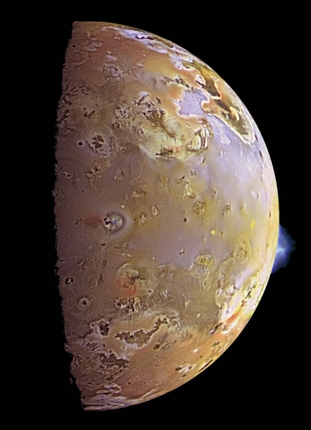 Image of Jupiter's moon Io, partially in shadow, in yellowish-beige colours and with some large-and small-scale structure to the surface. At one of the moon's edges, a whitish plume can be seen emanating from the surface. The plume is clearly visible at a height equal to approximately a ninth of the moon's radius