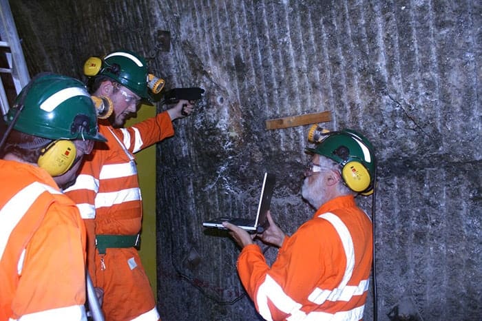 Photograph of Peter Edwards and colleagues using a Raman spectrometer in Boulby mine