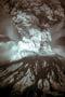 Photo of the 1980 eruption of Mount St Helens volcano, showing a towering cloud of ash emerging from the top of the peak