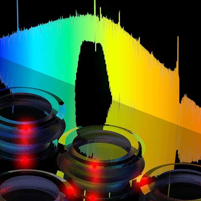 Photomontage showing a soliton frequency spectrum and glass microresonators