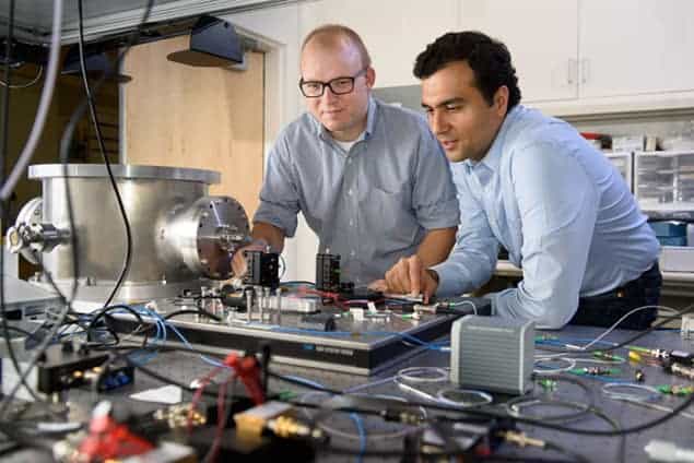 Photograph of Peter McMahon and Alireza Marandi with the Stanford Ising machine
