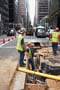 Photo of workers digging up a city street