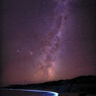 Photograph of the Milky Way and bioluminescent phytoplankton by Arwen Dyer in Tasmania