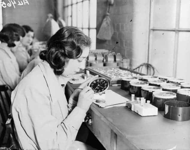 Female factory workers using radium paint on clock faces at the Ingersoll factory in 1932