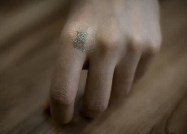 Photograph of a stretchable transistor on the skin of a hand