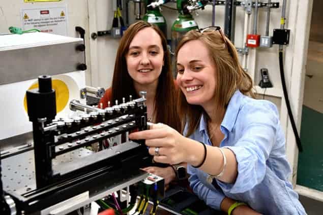 hotograph of Sarah Day (left) and Claire Corkhill (right) looking at the eight cement samples in the long duration experiment