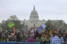 Large crowd holding protest signs in Washington DC