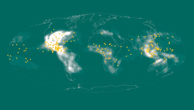 A world map with the locations of terrestrial gamma-ray flashes marked with yellow dots and regions with a high frequency of lightning shaded in white. The yellow dots and the white-shaded areas often overlap
