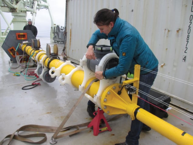 Photograph of Helen Czerski working on the buoy that holds her equipment