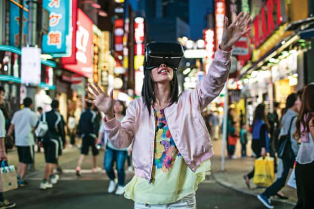 Photo of a young woman using virtual-reality goggles in Tokyo