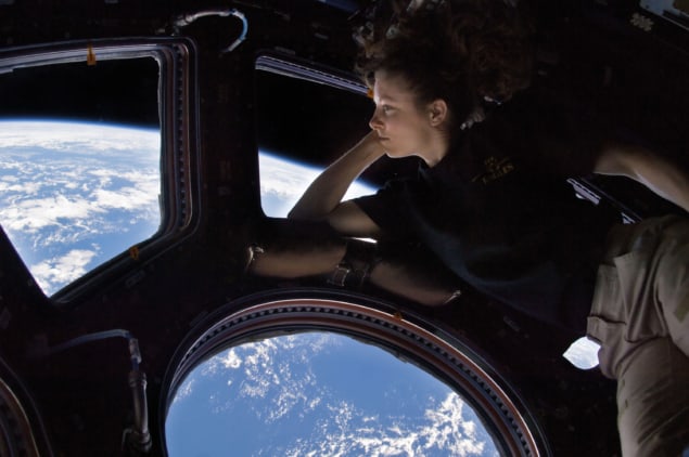 NASA astronaut Tracy Caldwell Dyson, Expedition 24 flight engineer, looks through a window in the Cupola of the International Space Station
