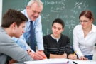 Teacher with a group of high school students in a classroom