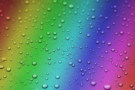 Photo of raindrops on a rainbow background