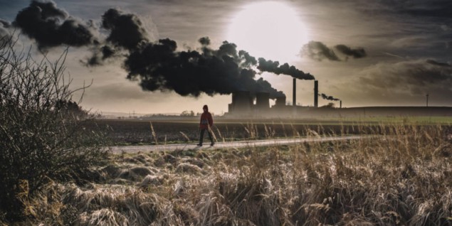 Photo of person walking past power station
