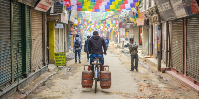 Photo of person transporting fuel cylinders by bike