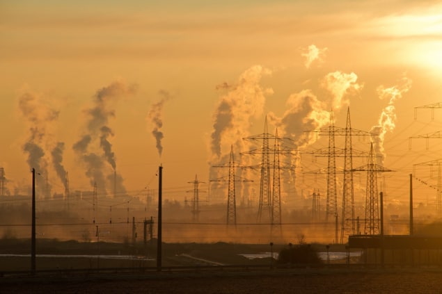 Photo of smoke rising from industrial chimneys Photo of smoke rising from industrial chimneys