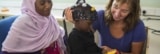 An optical measurement device being fitted to a child in The Gambia