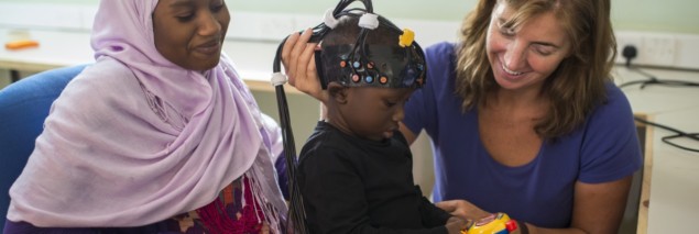 An optical measurement device being fitted to a child in The Gambia