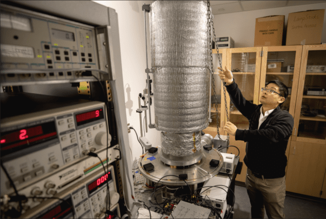 Lead researcher Linxiao Zhu in front of the high-vacuum, low-vibration chamber that housed the photodiode and calorimeter