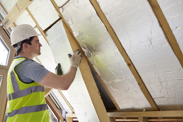 Photo of worker installing insulation