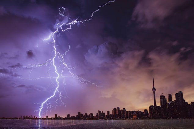 Photo of lightning over city skyline