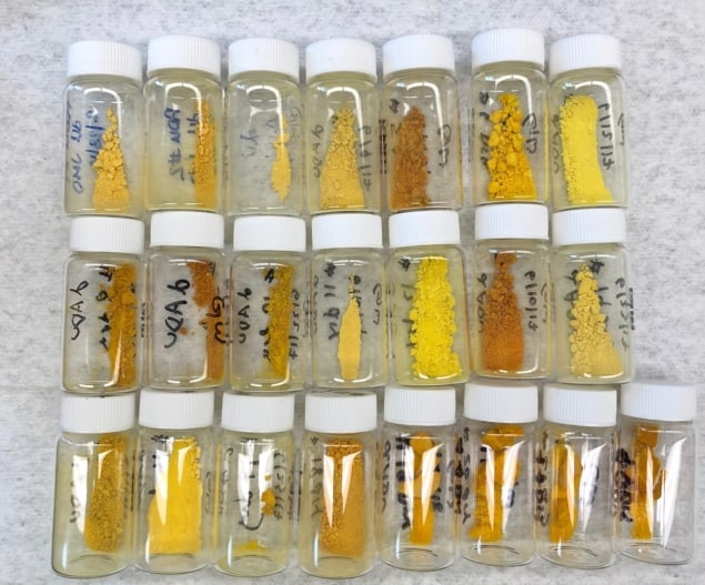 22 vials of powder, each one a slightly different shade of yellow-orange