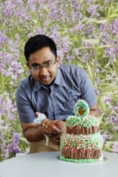 Rahul Mandal icing a cake