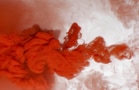 Abstract background of red acrylic paint in water.