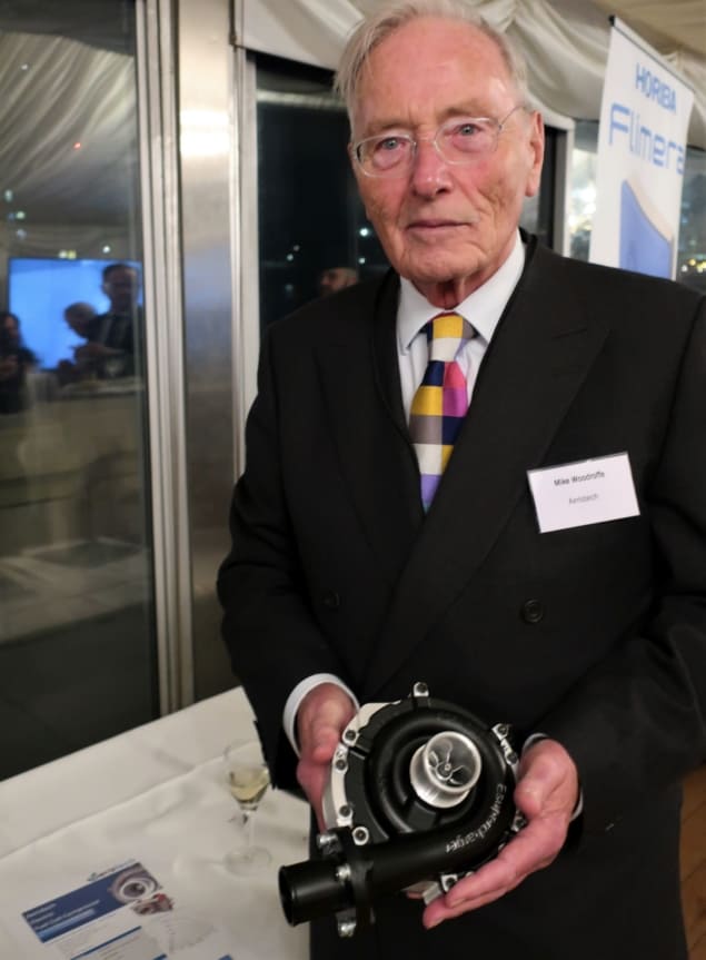 Mike Woodroffe holding a small silver-and-black device in his hands