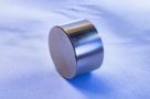 A small disc-shaped neodymium magnet